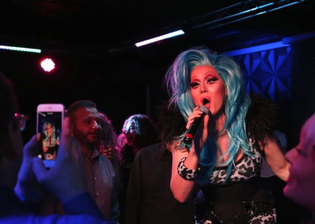 blue hair drag queen singing
