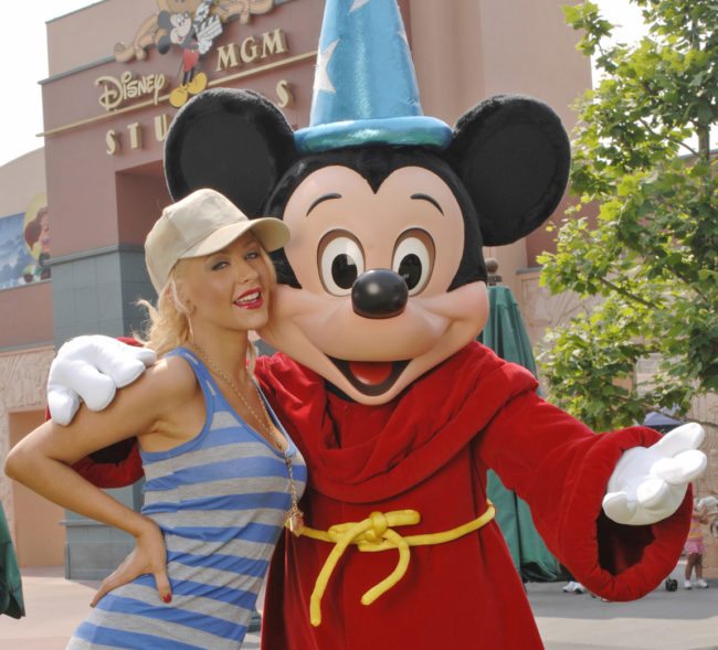 LAKE BUENA VISTA, FLORIDA - MAY 3: In this handout image provided by Disney, grammy Award-winning artist Christina Aguilera poses with Mickey Mouse at the Disney-MGM Studios on May 3, 2007 in Lake Buena Vista, Fla. It was a "homecoming" for Aguilera, who taped the Disney Channel's "The New Mickey Mouse Club" series at the Disney-MGM Studios as a child star in the early 1990s. (Photo by Diana Zalucky/Disney via Getty Images)