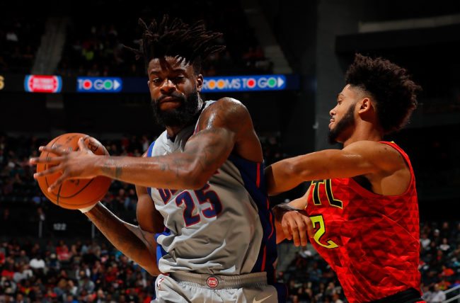 ATLANTA, GA - FEBRUARY 11:  Reggie Bullock #25 of the Detroit Pistons grabs a rebound against Tyler Dorsey #2 of the Atlanta Hawks at Philips Arena on February 11, 2018 in Atlanta, Georgia.  NOTE TO USER: User expressly acknowledges and agrees that, by downloading and or using this photograph, User is consenting to the terms and conditions of the Getty Images License Agreement.  (Photo by Kevin C. Cox/Getty Images)