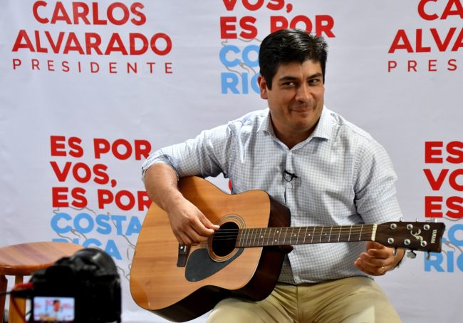 Costa Rican presidential candidate for the Citizen Action Party (PAC), Carlos Alvarado plays the guitar during a Facebook Live broadcast in San Jose, Costa Rica, on March 29, 2018.  Costa Rica faces a presidential runoff between Fabricio Alvarado, a 43-year-old lawmaker, pastor and singer with the National Restoration Party, and Carlos Alvarado, a former minister from the leftist ruling party. Despite the shared last name, the two men are unrelated. / AFP PHOTO / Ezequiel BECERRA        (Photo credit should read EZEQUIEL BECERRA/AFP/Getty Images)