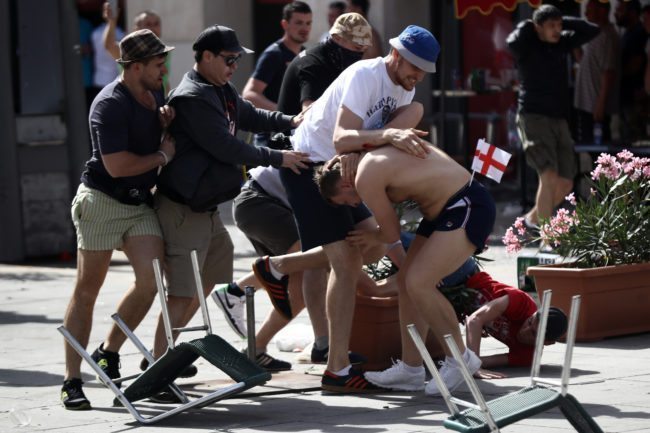MARSEILLE, FRANCE - JUNE 11: England fans clash with Russian fans ahead of the game against Russia later today on June 11, 2016 in Marseille, France. Football fans from around Europe have descended on France for the UEFA Euro 2016 football tournament. (Photo by Carl Court/Getty Images)