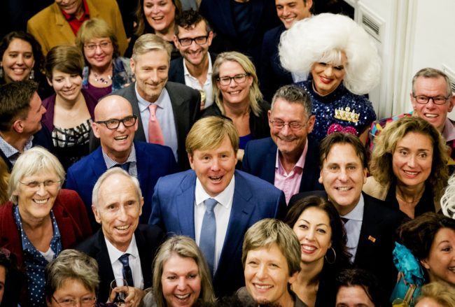 Dutch King Willem-Alexander (C) poses during a visit to COC Netherlands, an interest group for LGBT men and women, during a celebration for its 70th anniversary in Amsterdam, on November 22, 2016. / AFP / ANP / Robin van Lonkhuijsen / Netherlands OUT        (Photo credit should read ROBIN VAN LONKHUIJSEN/AFP/Getty Images)