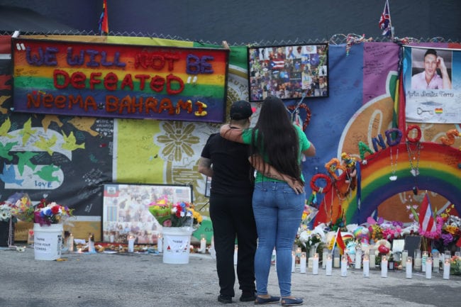 ORLANDO, FL - JUNE 12: Melinda Vargas and Natascha Soto (L-R) visit the memorial setup outside the Pulse gay nightclub as they remember those lost one year ago during a mass shooting on June 12, 2017 in Orlando, Florida. Omar Mateen killed 49 people at the club a little after 2 a.m. on June 12, 2016. (Photo by Joe Raedle/Getty Images)