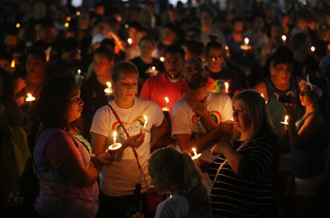 ORLANDO, FL - JUNE 12: People hold candles as they attend a one year anniversary memorial service for victims of the mass shooting at the Pulse gay nightclub being held at Lake Eola Park on June 12, 2017 in Orlando, Florida. Omar Mateen killed 49 people at the club a little after 2 a.m. on June 12, 2016. (Photo by Joe Raedle/Getty Images)