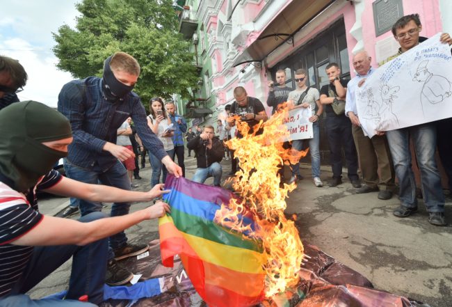 Far-right activists burn the rainbow flag during Kyiv Pride 2017 (SERGEI SUPINSKY/AFP/Getty)