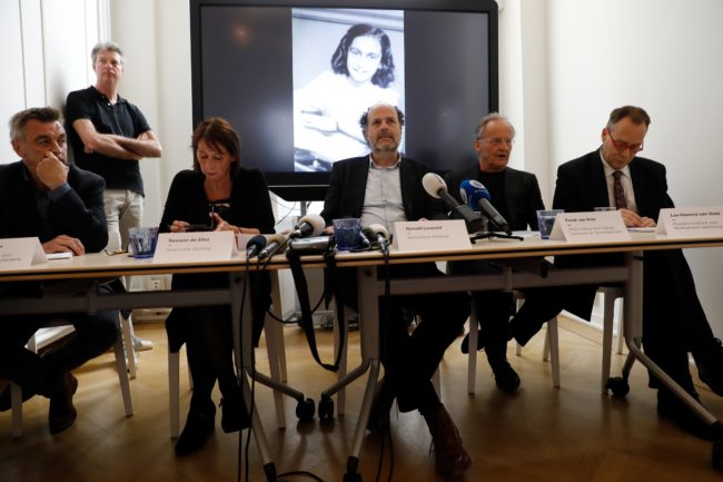 Researchers speak in front of a screen displaying a picture of Anne Frank as the Anne Frank House publishes unknown text of the young Jew who hid from the Nazis with her family in the Dutch capital, on May 15, 2018 in Amsterdam. - Two pages from her world-famous diary have been made visible with digital photo-editing techniques. (Photo by - / ANP / AFP) / Netherlands OUT        (Photo credit should read -/AFP/Getty Images)