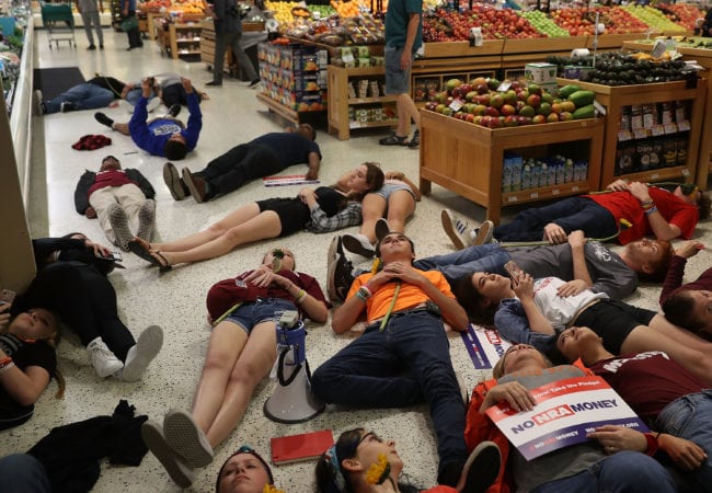CORAL SPRINGS, FL - MAY 25: Protesters participate in a "die'-in" protest in a Publix supermarket on May 25, 2018 in Coral Springs, Florida. The activists many of whom are Marjory Stoneman Douglas High School students entered the Publix store to protest against the company's support of political candidates endorsed by the National Rifle Association who oppose gun reform. (Photo by Joe Raedle/Getty Images)