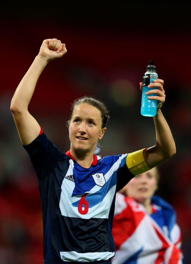 LONDON, ENGLAND - JULY 31:  Casey Stoney #6 of Great Britain waves to the crowd draped in a Union Jack as she celebrates her team's victory after the Women's Football first round Group E Match between Great Britain and Brazil on Day 4 of the London 2012 Olympic Games at Wembley Stadium on July 31, 2012 in London, England.  (Photo by Julian Finney/Getty Images)