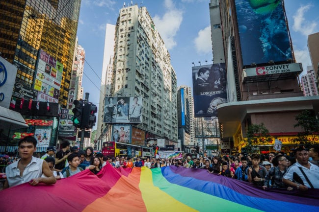 Participants carry a large flag as they take part in a Gay Pride procession in Hong Kong on November 10, 2012.  As anti-discrimination laws continues to expand globally, the participant marched to promote equal rights for lesbian, gay, bisexual and transgender (LGBT).  AFP PHOTO / Philippe Lopez        (Photo credit should read PHILIPPE LOPEZ/AFP/Getty Images)