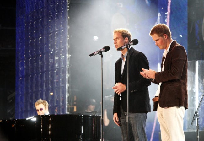 LONDON - JULY 01:  Their Royal Highnesses Prince William (L) and Prince Harry (R) speak on stage with Sir Elton John (far L) at the piano at the Concert for Diana at Wembley Stadium on July 1, 2007 in London, England. The Concert falls on the date that would have been the late Princess's 46th birthday and marks 10 years since her death with an event headed by Princes William and Harry to celebrate her life.  (Photo by Getty Images/Getty Images)