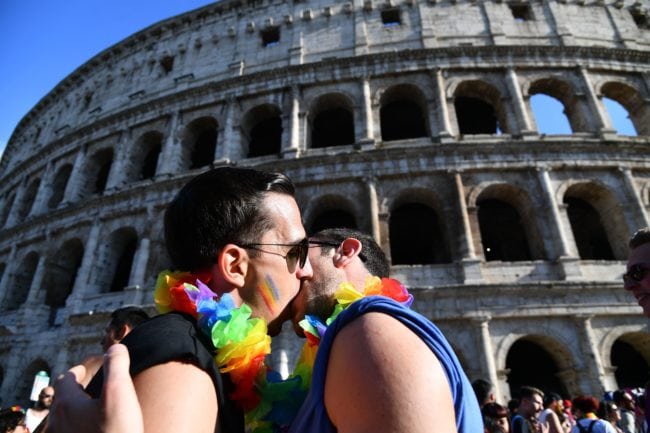 Revellers pose in front of the Coliseum during the Gay Pride Parade in Rome on June 9, 2018. (Photo by Vincenzo PINTO / AFP) (Photo credit should read VINCENZO PINTO/AFP/Getty Images)
