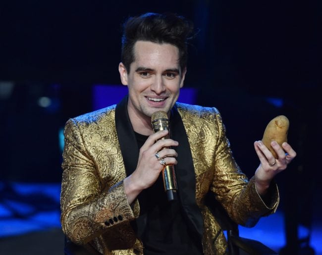 Lead singer of US band Panic! At The Disco, Brendon Urie, holds a potato that was given to him as a gift, on stage at the iHeartRadio Album Release Party at the iHeartRadio Theater in Burbank, California on June 21, 2018. - Urie performed songs from the group's new album "Pray For The Wicked." (Photo by Robyn Beck / AFP)        (Photo credit should read ROBYN BECK/AFP/Getty Images)