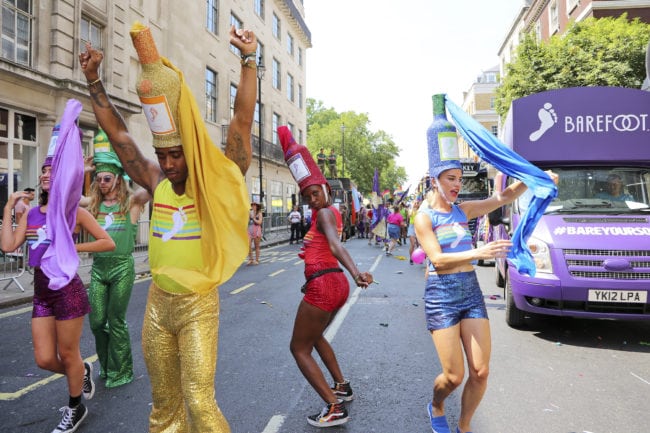 LONDON, ENGLAND - JULY 07: Barefoot Wine are the official wine sponsor of Pride In London and have been a proud ally of the LGBTQ community since 1988. They celebrated in this years parade with 6 dancing wine bottles matching the 6 different colours of the pride rainbow on July 7, 2018 in London, England. 