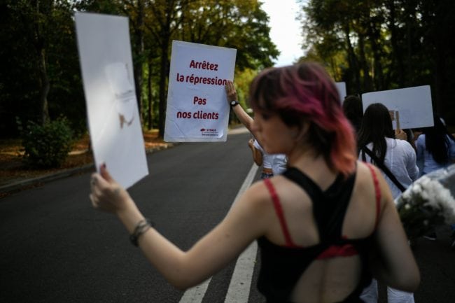 People hold placards reading "stop repression, not our clients", during a march at the Bois de Boulogne in Paris, on August 24, 2018, in tribute to Vanesa Campos, a 36 year-old transsexual sex worker who was killed the week before. (Photo by Lionel BONAVENTURE / AFP)        (Photo credit should read LIONEL BONAVENTURE/AFP/Getty Images)