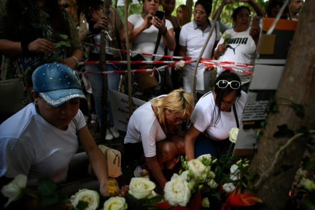 People lay white roses at a makeshift memorial in tribute to Vanesa Campos, a 36 year-old transsexual sex worker who was killed the week before, at the Bois de Boulogne in Paris, on August 24, 2018. (Photo by Lionel BONAVENTURE / AFP)        (Photo credit should read LIONEL BONAVENTURE/AFP/Getty Images)