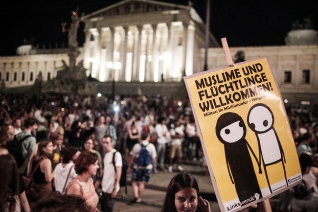 Protesters gather to demonstrate against ill-treatment of migrants after the bodies of 71 refugees were found in an abandoned truck last week in Vienna on August 31, 2015. Around 20,000 people demonstrated police said. The banner reads 'Muslims and refugees welcome'. AFP PHOTO / PATRICK DOMINGO (Photo credit should read PATRICK DOMINGO/AFP/Getty Images)