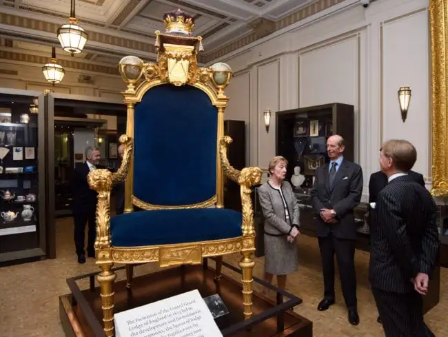 LONDON, ENGLAND - SEPTEMBER 29: Prince Edward, Duke of Kent (C), also the 10th Grand Master of the United Grand Lodge of England, is shown the Grand Master's Chair by Director of the Library and Museum, Diane Clements (L), during a visit to open a gallery titled 'Three Centuries of English Freemasonry' at the Library and Museum of Freemasonry on September 29, 2016 in London, England. To mark Freemasonry's 300th anniversary, a new permanent gallery space is being opened and features items including Winston Churchill's Masonic apron and the Grand Master's Throne. (Photo by Carl Court/Getty Images)