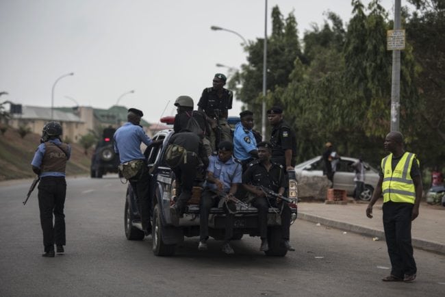 Members of the Nigerian police pursue protesters from the Islamic Movement of Nigeria (IMN) in Abuja on April 17, 2018.  Nigerian police fired teargas for a second day on April 17 at protesters demanding the release of Shiite leader Ibrahim Zakzaky, who has been in jail without charge since December 2015.  / AFP PHOTO / STEFAN HEUNIS        (Photo credit should read STEFAN HEUNIS/AFP/Getty Images)