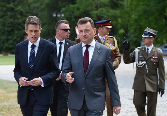 UK Defence Secretary Gavin Williamson (L) and Polish Defence Minister Mariusz Blaszczak walk together in Helenow, near Warsaw on June 21, 2018 at the begining of their talks about strengthening security, defence, and cyber ties between both countries. (Photo by JANEK SKARZYNSKI / AFP)        (Photo credit should read JANEK SKARZYNSKI/AFP/Getty Images)