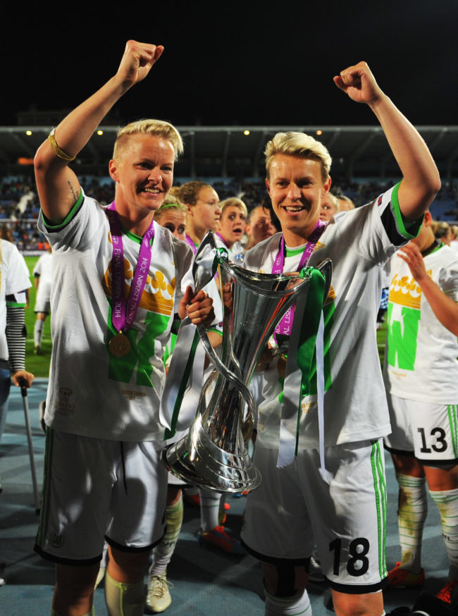 LISBON, PORTUGAL - MAY 22:  Nilla Fischer (L) and Ivonne Hartmann of VfL Wolfsburg celebrate with the trophy after victory during the UEFA Women's Champions Final match between Tyreso FF and Wolfsburg at Do Restelo Stadium on May 22, 2014 in Lisbon, Portugal.  (Photo by Michael Regan/Getty Images)
