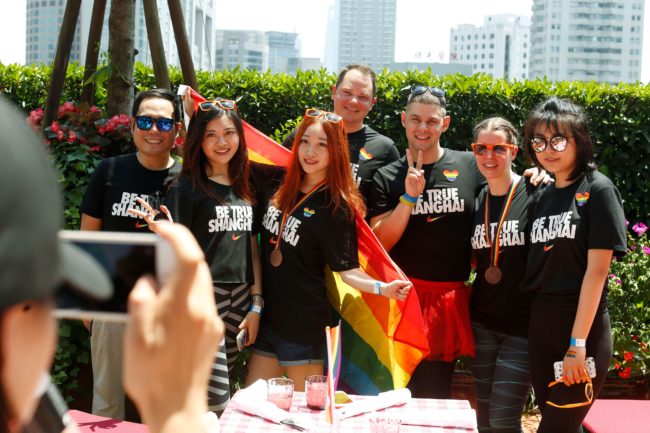 A group poses for photos after taking part in the Pride Run in Shanghai on June 17, 2017. The run was part of Shanghai's ninth annual gay-pride festival. / AFP PHOTO / STR / China OUT (Photo credit should read STR/AFP/Getty Images)