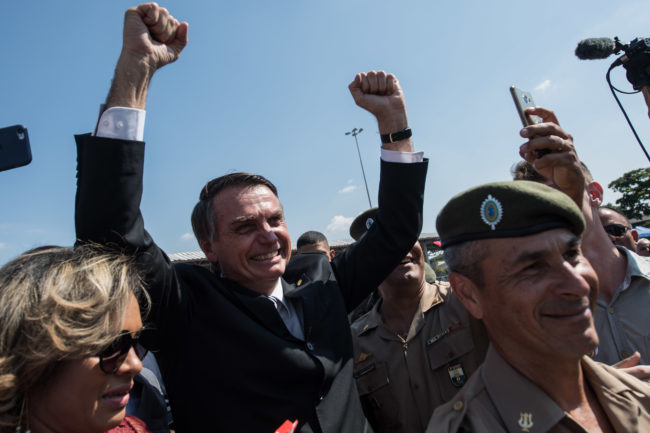 Brazilian congressman and presidential canditate for the next election, Jair Bolsonaro (R), cheer the crowd during a military event in Sao Paulo, Brazil on May 3, 2018. (Photo by Nelson ALMEIDA / AFP) (Photo credit should read NELSON ALMEIDA/AFP/Getty Images)