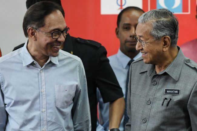 Malaysia's Prime Minister Mahathir Mohamad (R) and politician Anwar Ibrahim, leave after a press conference in Kuala Lumpur on June 1, 2018. (Photo by Mohd RASFAN / AFP) (Photo credit should read MOHD RASFAN/AFP/Getty Images)