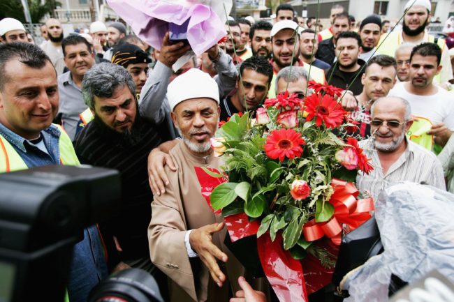 SYDNEY, AUSTRALIA - NOVEMBER 03: Controversial muslim cleric Sheik Taj el-Din al Hilaly offers flowers to the media after Friday prayers at Lakemba mosque November 3, 2006 in Sydney, Australia. Hilaly spoke at the prayers in his first public appearance since being hospitalized on October 30, 2006. The mufti has faced criticism in Australia following a sermon last month in which he suggested that immodestly dressed women invited sexual assault. (Photo by Ian Waldie/Getty Images)