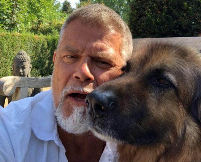 Emile Ratelband, who is suing to change his age, with a dog