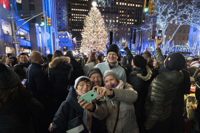 People gather around the Rockefeller Center tree.