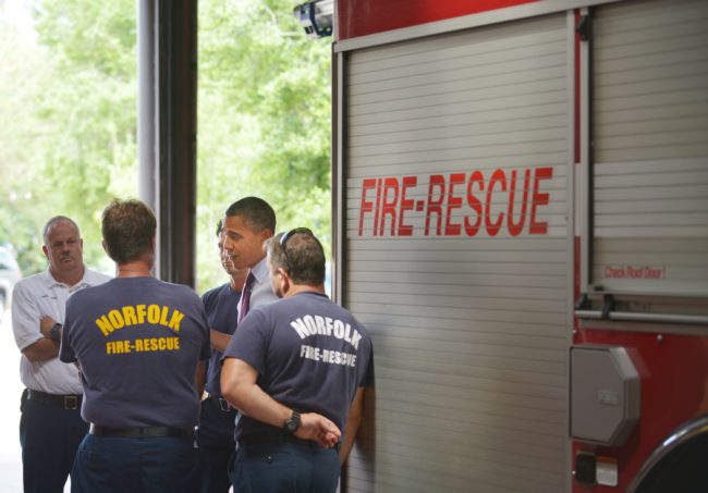 US President Barack Obama chats with firefighters during an unannounced stop at Fire Station No. 14 September 4, 2012 in Norfolk, Virginia, where the gay firefighters served until 2017.