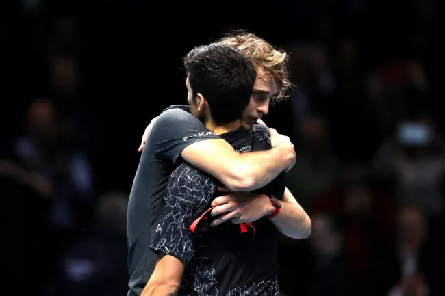 Alexander Zverev of Germany shares a hug with Novak Djokovic of Serbia at the ATP Finals