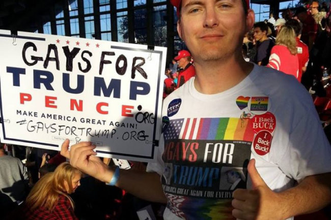 Peter Boykin poses with a 'Gays for Trump' sign