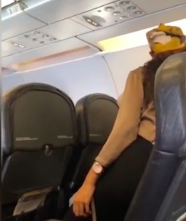 Woman leans over and insults fellow plane passenger with homophobic slurs 