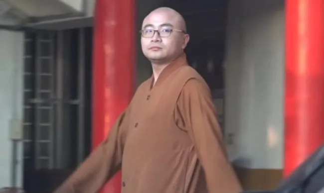 Buddhist monk Kai Hung walks past in full garb