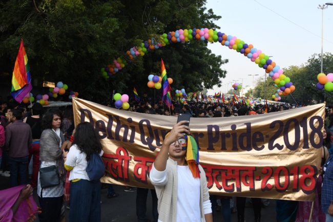 A participant takes a picture on his smartphone as Indian LGBT people celebrate in Delhi