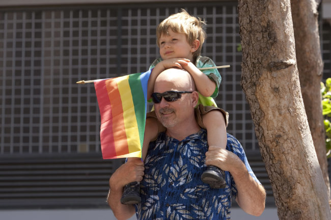 A man holds his son at the Pride parade in San Francisco, California. 