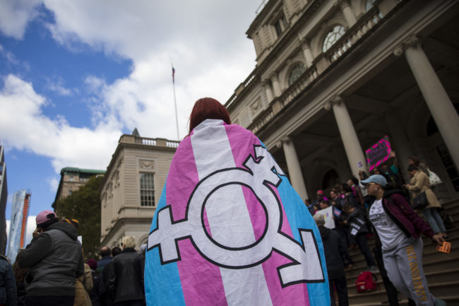 A person in a transgender flag