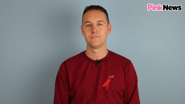 HIV activist Tom Hayes wears a World AIDs Day ribbon