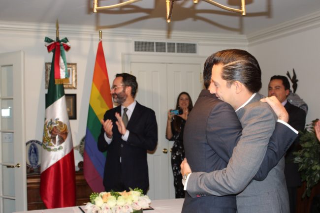 Gay Mexican couple embrace after being declared married.
