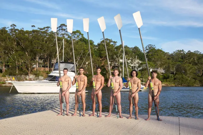 Warwick Rowers pose at a boat house