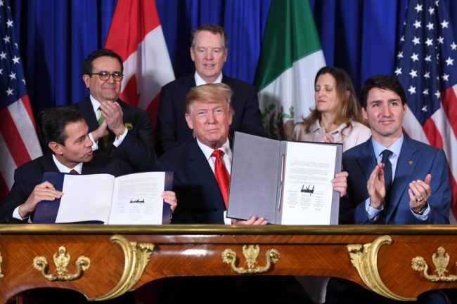 Mexico's President Enrique Pena Nieto, US President Donald Trump, and Canadian Prime Minister Justin Trudeau, sign a new USMCA free trade agreement in Buenos Aires, on November 30, 2018.