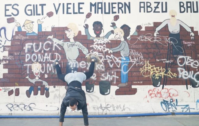 Queer dance protester Nasr twerks against a section of the Berlin Wall