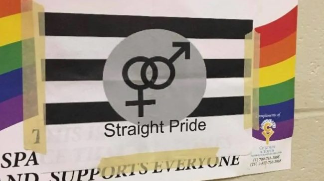 A 'Straight Pride' flag is plastered over the top of a Gay-Straight Alliance poster at the Canada school