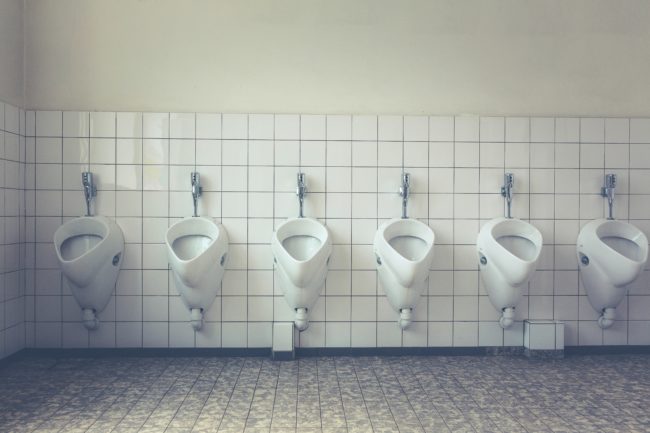 A row of urinals in a bathroom