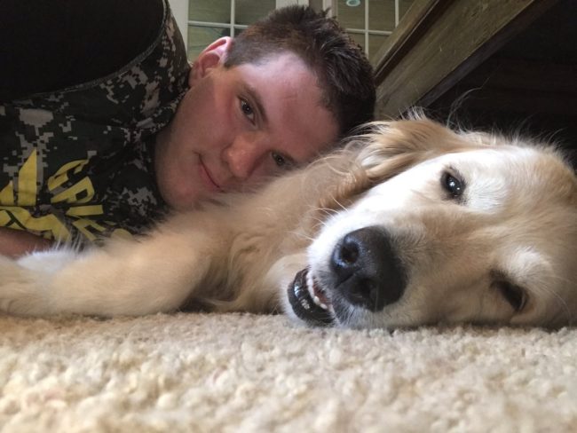 Christian Zeitvogel poses for a photo with his dog which he posted on Twitter