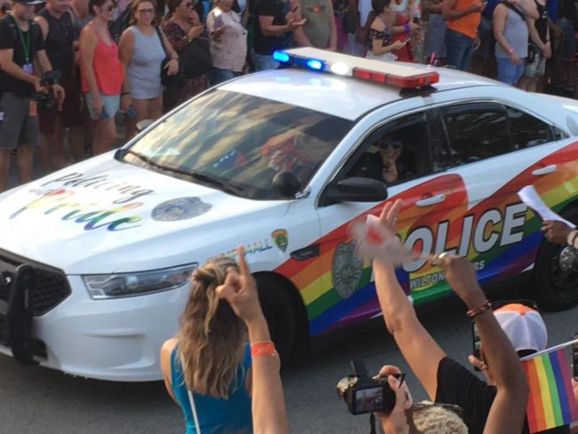 A police car takes part in Fort Lauderdale Gay Pride, where two people were stabbed on Sunday.