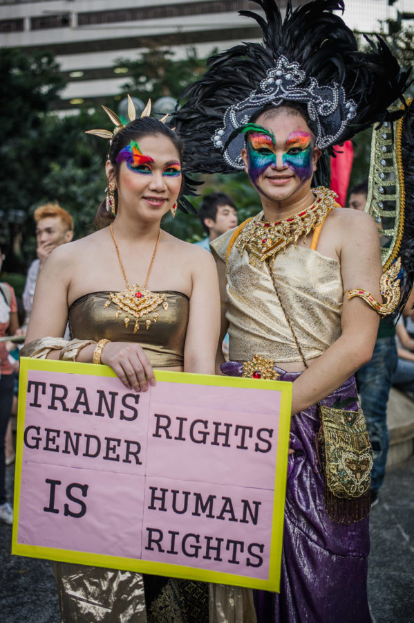 Participants display a placard during a Gay Pride parade in Hong Kong on November 10, 2012 with lesbian, gay, bisexual and transgender people