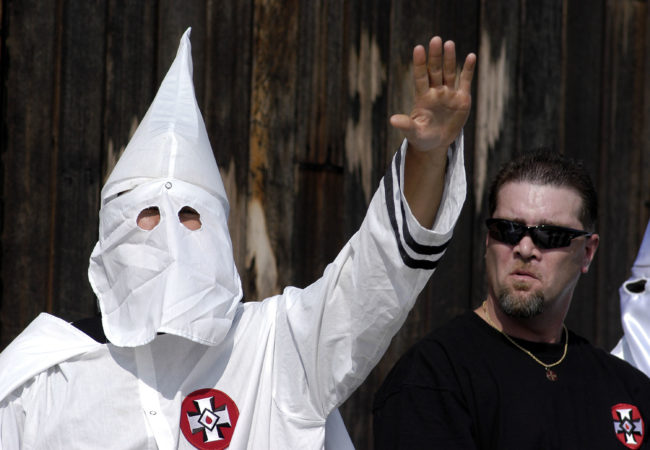 A Ku Klux Klan member, just like the ones West Virginia Republican lawmaker Eric Porterfield compared the LGBT+ community to, salutes during an American Nazi Party rally at Valley Forge National Park September 25, 2004 in Valley Forge, Pennsylvania