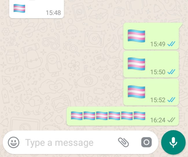 A screenshot of the transgender Pride flag emoji being used on WhatsApp.